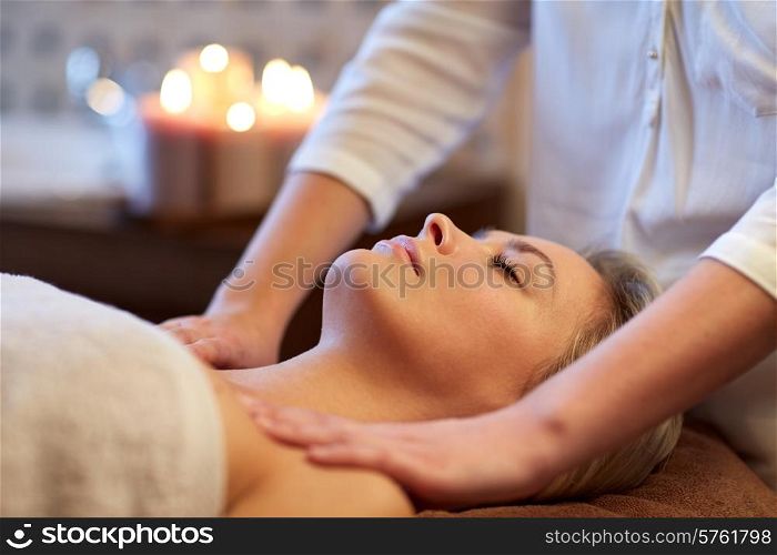 people, beauty, spa, healthy lifestyle and relaxation concept - close up of beautiful young woman lying with closed eyes and having massage in spa