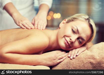 people, beauty, spa, healthy lifestyle and relaxation concept - close up of beautiful young woman lying with closed eyes and having hand massage in spa