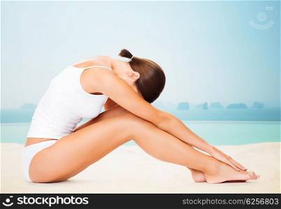 people, beauty, spa, yoga and fitness concept - beautiful woman in cotton underwear over infinity edge pool background