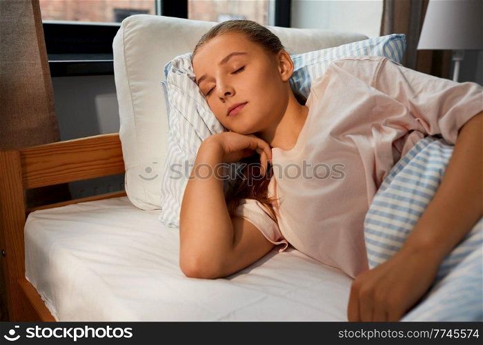 people, bedtime and rest concept - girl sleeping in bed at home. girl sleeping in bed at home