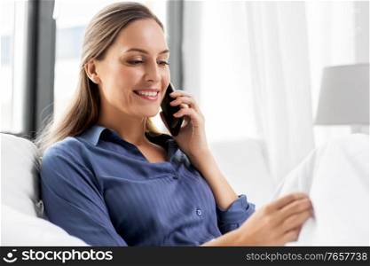 people, bedtime and rest concept - happy smiling woman calling on smartphone in bed at home. happy woman calling on smartphone in bed at home