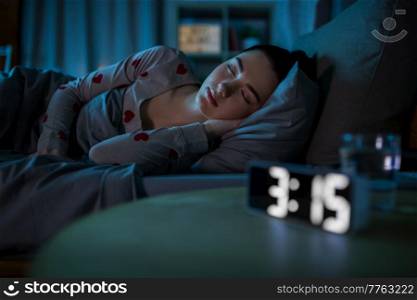 people, bedtime and rest concept - teenage girl sleeping at home at night. teenage girl sleeping at home at night