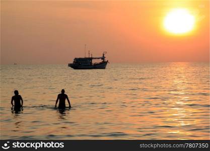 People, boat and sea with sunset in Thailand