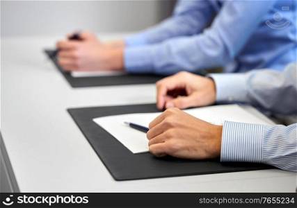 people, business and corporate concept - close up of businessman with papers at office. close up of businessman with papers at office