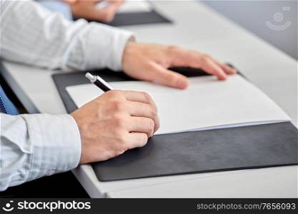 people, business and corporate concept - close up of businessman with pen and paper at office. close up of businessman with paper at office
