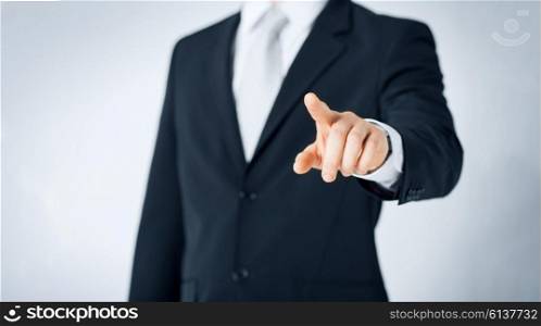 people, business and gesture concept - close up of man pointing finger to to something