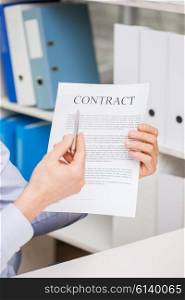 people, business and paperwork concept - close up of smiling businessman holding contract document