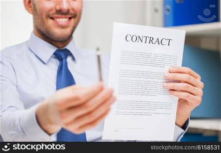 people, business and paperwork concept - close up of smiling businessman holding contract document