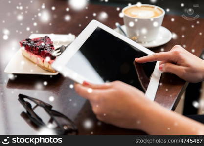 people, business and technology concept - close up of hands with tablet pc computer, eyeglasses, coffee cup and berry cake on table over snow