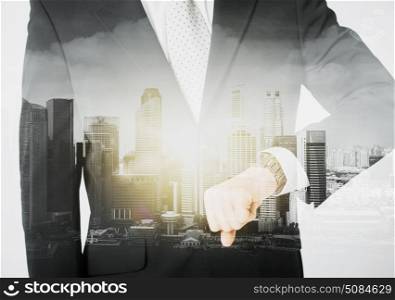 people, business and time concept - close up of businessman with wristwatch over city with double exposure. close up of businessman with wristwatch. close up of businessman with wristwatch