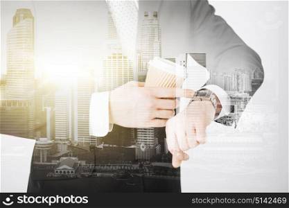 people, business and time concept - close up of businessman with wristwatch and coffee over city with double exposure. close up of businessman with wristwatch and coffee
