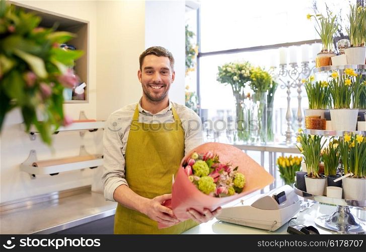 people, business, sale and floristry concept - happy smiling florist man with bunch at flower shop