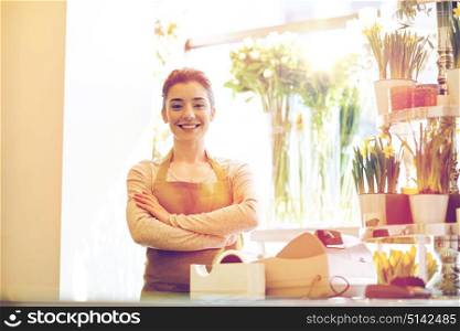people, business, sale and floristry concept - happy smiling florist woman at flower shop cashbox. smiling florist woman at flower shop cashbox