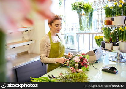 people, business, sale and floristry concept - happy smiling florist woman making bunch at flower shop