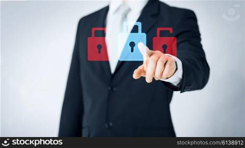 people, business, security, protection and safety concept - close up of man pointing finger to lock icon projection