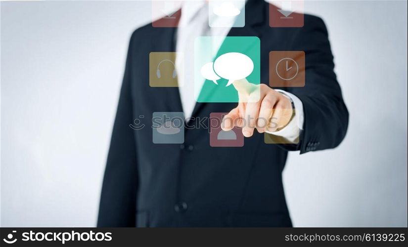 people, business, technology and communication concept - close up of man pointing finger to messenger icon projection