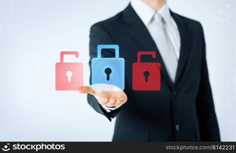 people, business, technology and concept - close up of man hand showing lock icon projection