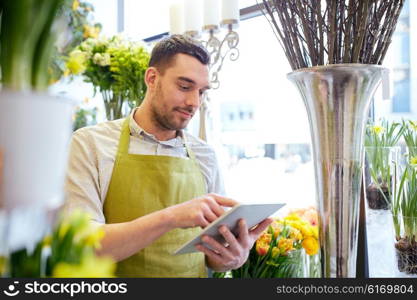 people, business, technology, sale and floristry and concept - happy smiling florist man with tablet pc computer at flower shop