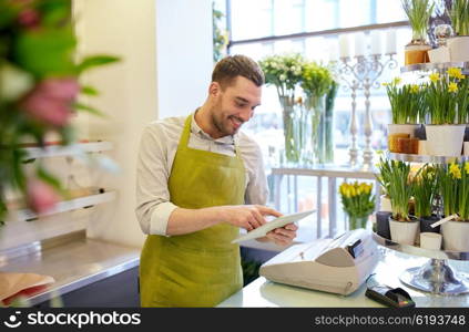 people, business, technology, sale and floristry and concept - happy smiling florist man with tablet pc computer at flower shop counter