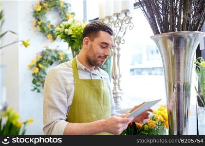 people, business, technology, sale and floristry and concept - happy smiling florist man with tablet pc computer at flower shop