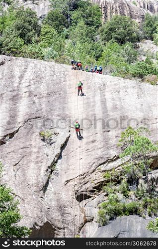 people canyoning in the famous Purcaraccia Canyon in Bavella during summer, a tourist destination and attraction for canyoning, hiking and visiting the natural pools. Corsica, France. Purcaraccia Canyon in Bavella, Corsica. France