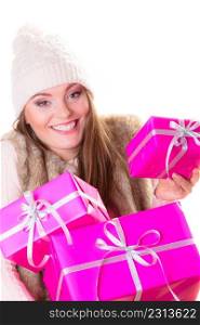 People celebrating christmas, xmas love and happiness concept - girl in warm winter clothes with many pink gift boxes isolated