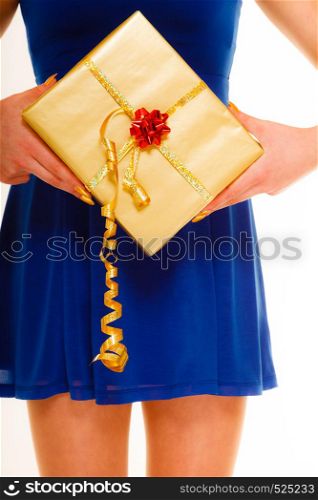 People celebrating holidays, love and happiness concept - girl blue dress with golden gift box isolated