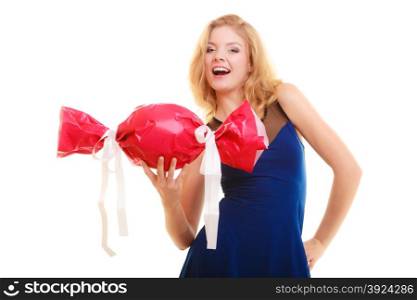 People celebrating holidays, love and happiness concept - smiling girl holding big red gift candy shaped isolated