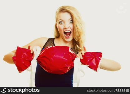 People celebrating holidays, love and happiness concept - smiling girl holding big red gift candy shaped studi shot on gray