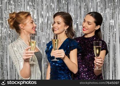 people, celebration and holidays concept - happy women toasting champagne glasses at party. happy women toasting champagne glasses at party