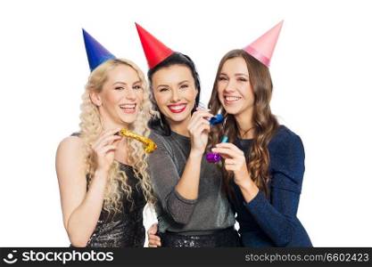 people, celebration and holidays concept - happy women with party caps and blowers. happy women with party caps hugging