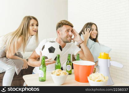 people cheering watching football match home