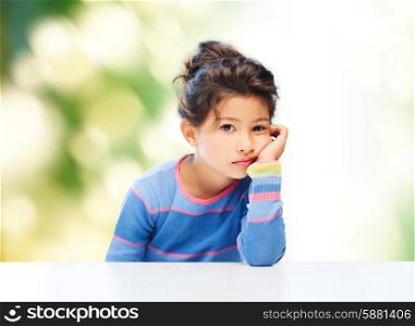 people, childhood and emotions concept - sad little girl over green background