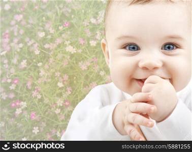 people, childhood, spring and happiness concept - close up of happy smiling baby over floral background