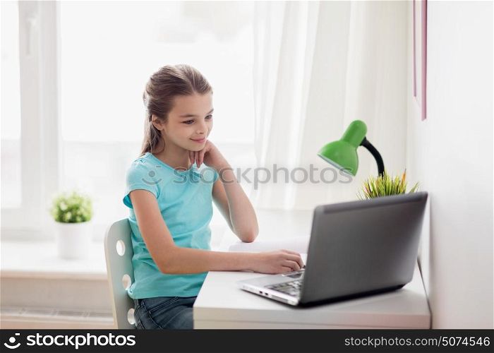 people, children and technology concept - girl with laptop computer at home. girl with laptop at home