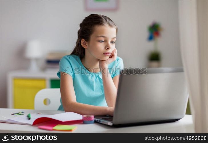 people, children, education and learning concept - bored girl with laptop computer and to notebook at home. bored girl with laptop and notebook at home