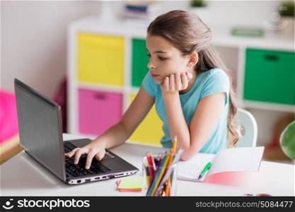 people, children, education and learning concept - bored girl with laptop computer and to notebook at home. bored girl with laptop and notebook at home. bored girl with laptop and notebook at home