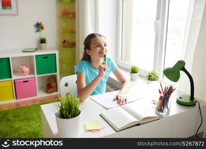 people, children, education and learning concept - happy girl with book and notebook doing homework and looking up at home. happy girl with book and notebook dreaming at home