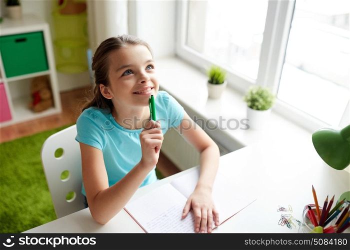 people, children, education and learning concept - happy girl with notebook looking up and dreaming at home. happy girl with notebook dreaming at home. happy girl with notebook dreaming at home