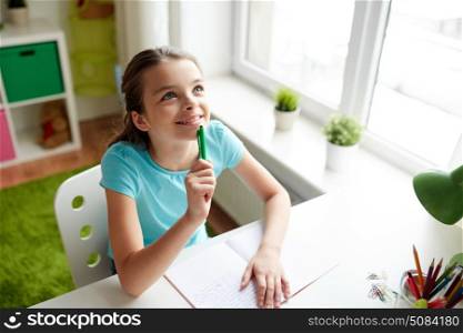 people, children, education and learning concept - happy girl with notebook looking up and dreaming at home. happy girl with notebook dreaming at home. happy girl with notebook dreaming at home