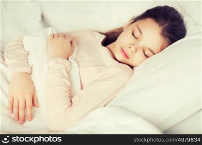 people, children, rest and comfort concept - girl sleeping in bed at home. girl sleeping in bed at home