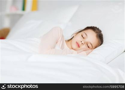 people, children, rest and comfort concept - girl sleeping in bed at home