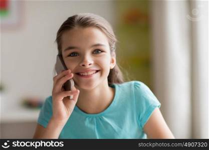 people, children, technology and communication concept - close up of smiling girl calling on smartphone at home. close up of girl calling on smartphone at home