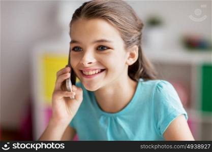 people, children, technology and communication concept - close up of smiling girl calling on smartphone at home. close up of girl calling on smartphone at home