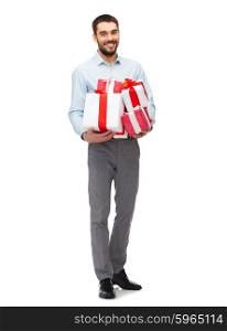 people, christmas, birthday and holidays concept - happy young man holding gift boxes