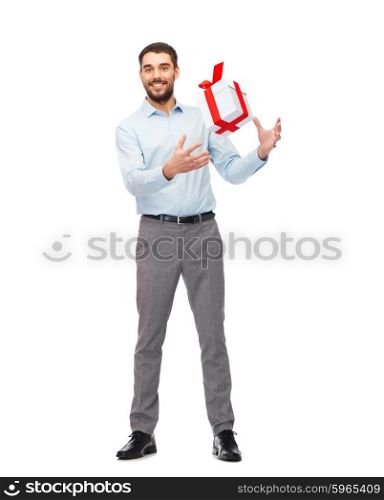 people, christmas, birthday and holidays concept - happy young man playing with gift box