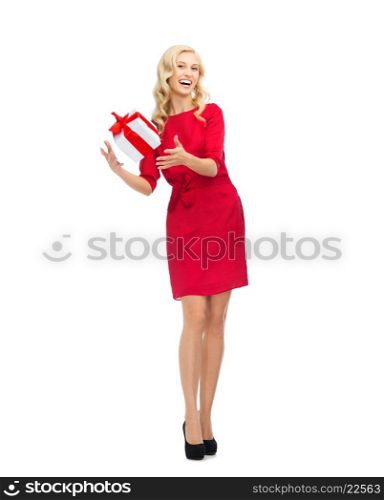 people, christmas, birthday and holidays concept - happy young woman in red dress playing with gift box