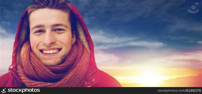 people, christmas, winter and season concept - close up of happy smiling man in hood and scarf outdoors. close up of happy man in winter jacket with hood