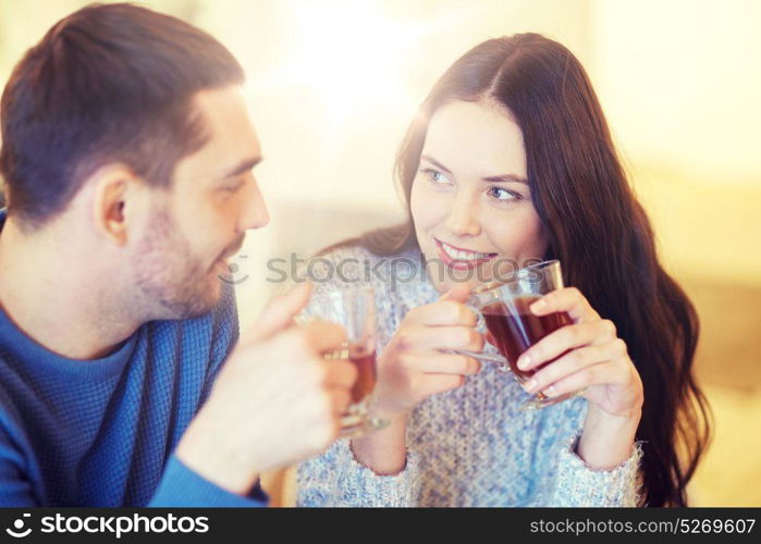 people, communication and dating concept - happy couple drinking tea at cafe or restaurant. happy couple drinking tea at cafe