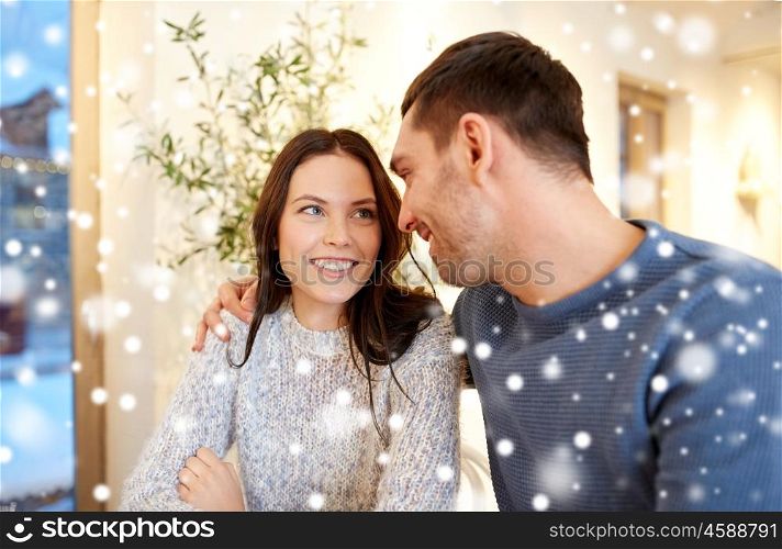 people, communication and dating concept - happy couple hugging at cafe or restaurant. happy couple hugging at cafe or restaurant